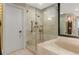 Bright bathroom boasts glass shower, soaking tub, and modern fixtures for a spa-like experience at 2660 Peachtree Nw Rd # 13F, Atlanta, GA 30305