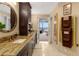 A luxurious bathroom vanity with a marble countertop, a large mirror, and a view of the bedroom at 2660 Peachtree Nw Rd # 13F, Atlanta, GA 30305