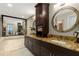 A luxurious bathroom with a double sink vanity, granite countertop, and a large mirror reflecting natural light at 2660 Peachtree Nw Rd # 13F, Atlanta, GA 30305