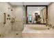 A well-appointed bathroom featuring a glass-enclosed shower, soaking tub, and sleek fixtures at 2660 Peachtree Nw Rd # 13F, Atlanta, GA 30305