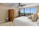 Bright bedroom featuring a ceiling fan, walk-out balcony, and a large window showcasing the city at 2660 Peachtree Nw Rd # 13F, Atlanta, GA 30305