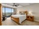 Serene bedroom with a ceiling fan, walk-out balcony, and a large window showcasing the city at 2660 Peachtree Nw Rd # 13F, Atlanta, GA 30305