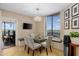 Sunlit breakfast nook featuring built-in bench seating, a modern chandelier, and scenic views at 2660 Peachtree Nw Rd # 13F, Atlanta, GA 30305