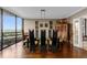 Open dining area featuring dark wood floors, modern furniture, and abundant natural light with stunning views at 2660 Peachtree Nw Rd # 13F, Atlanta, GA 30305