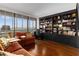 Comfortable living room with built-in bookshelves and large windows with a view at 2660 Peachtree Nw Rd # 13F, Atlanta, GA 30305