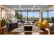 Bright living room featuring hardwood floors, multiple seating areas, and expansive windows with city views at 2660 Peachtree Nw Rd # 13F, Atlanta, GA 30305