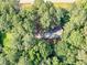 An aerial view of the home, nestled among the surrounding trees at 1000 Coan Dr, Locust Grove, GA 30248