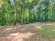 Large backyard featuring playground equipment and a wooden canopy at 1000 Coan Dr, Locust Grove, GA 30248