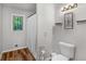 Bright bathroom featuring wood flooring and a window providing natural light at 1000 Coan Dr, Locust Grove, GA 30248
