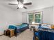 Bedroom featuring two beds, ceiling fan, and natural light from a window at 1000 Coan Dr, Locust Grove, GA 30248