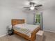 Comfortable bedroom with a ceiling fan, a bedside table, and a footlocker at 1000 Coan Dr, Locust Grove, GA 30248