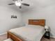 Comfortable bedroom with a ceiling fan, a bedside table, and a painting at 1000 Coan Dr, Locust Grove, GA 30248