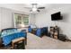 Shared bedroom featuring two beds, a ceiling fan, and a window at 1000 Coan Dr, Locust Grove, GA 30248