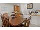 Dining room with wood table, chairs, and kitchen access at 1000 Coan Dr, Locust Grove, GA 30248