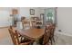Traditional dining room with wood table, chairs, carpet, and bright light from large window at 1000 Coan Dr, Locust Grove, GA 30248