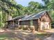 A wooden house with an attached two-car garage and sprawling front yard at 1000 Coan Dr, Locust Grove, GA 30248