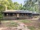 Charming single-story log cabin-style home with a covered front porch and wooded surroundings at 1000 Coan Dr, Locust Grove, GA 30248