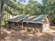 Beautiful single-story wood home featuring a charming front porch and attached garage nestled in a wooded lot at 1000 Coan Dr, Locust Grove, GA 30248