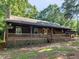 Inviting single-story house features a full-length porch, perfect for relaxing outdoors at 1000 Coan Dr, Locust Grove, GA 30248