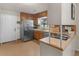 Kitchen featuring stainless steel refrigerator, wood cabinets, and tile floors at 1000 Coan Dr, Locust Grove, GA 30248