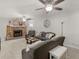 Spacious living room featuring a stone fireplace, comfortable seating, and neutral carpet at 1000 Coan Dr, Locust Grove, GA 30248