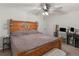 Comfortable main bedroom featuring a rustic wooden bed frame and bedside table at 1000 Coan Dr, Locust Grove, GA 30248