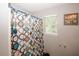Bathroom featuring a colorful shower curtain with an artistic bubble design and a window at 1964 Cutters Mill Way, Lithonia, GA 30058