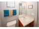 Bathroom featuring neutral paint, decorative towels, a small vanity and standard toilet at 1964 Cutters Mill Way, Lithonia, GA 30058