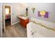 Bathroom boasts a corner tub with decorative accents, vanity, and access to the bedroom at 1964 Cutters Mill Way, Lithonia, GA 30058