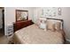 Cozy bedroom boasts a decorative mirror and a comfortable bed with stylish bedding at 1964 Cutters Mill Way, Lithonia, GA 30058