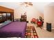 Bright bedroom features a built-in desk, shelving, and a mini fridge, creating a versatile and comfortable space at 1964 Cutters Mill Way, Lithonia, GA 30058