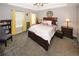 Bedroom with tray ceilings, a ceiling fan, and large windows for natural light, enhancing the room's appeal at 1964 Cutters Mill Way, Lithonia, GA 30058