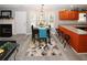 Cozy dining area with a chandelier, lots of windows, and gray wood-look flooring adjacent to the kitchen at 1964 Cutters Mill Way, Lithonia, GA 30058