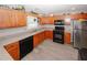 Functional kitchen features warm wood cabinets, stainless appliances, and durable countertops at 1964 Cutters Mill Way, Lithonia, GA 30058
