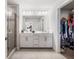 Bright bathroom boasts a double vanity, large mirror, glass shower, and organized walk-in closet at 505 Hampton Crossing, Woodstock, GA 30188