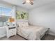 Cozy bedroom with neutral tones, a ceiling fan, and a bright window with blinds and curtains at 505 Hampton Crossing, Woodstock, GA 30188