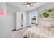 Bright bedroom with a ceiling fan, a window with blinds, and a wardrobe with mirrored doors at 505 Hampton Crossing, Woodstock, GA 30188