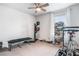 Bedroom set up as exercise room with bike, bench, boxing dummy, and many pairs of shoes at 505 Hampton Crossing, Woodstock, GA 30188