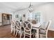 Formal dining room with hardwood floors, elegant chandelier, and seating for eight at 505 Hampton Crossing, Woodstock, GA 30188
