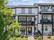 Townhome featuring a black front door, covered porch, and manicured landscaping creating curb appeal at 505 Hampton Crossing, Woodstock, GA 30188