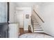 Inviting foyer features hardwood floors, staircase, and decorative dresser at 505 Hampton Crossing, Woodstock, GA 30188