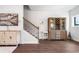 Hallway area featuring wood floors, wooden staircase, and stylish decorative furnishings at 505 Hampton Crossing, Woodstock, GA 30188
