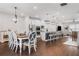 Open concept kitchen and dining area with stainless steel appliances and modern lighting fixtures at 505 Hampton Crossing, Woodstock, GA 30188