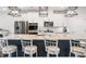 Bright kitchen features island with seating, stainless appliances and granite countertops at 505 Hampton Crossing, Woodstock, GA 30188