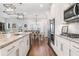 Bright open concept kitchen features stainless appliances, granite countertops, and modern pendant lighting at 505 Hampton Crossing, Woodstock, GA 30188