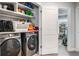 Open laundry room features new washer and dryer, plus shelf space for added storage at 505 Hampton Crossing, Woodstock, GA 30188