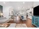 Open floor plan with kitchen, living room, staircase, and hardwood floors at 505 Hampton Crossing, Woodstock, GA 30188