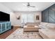 Bright living room featuring hardwood floors, modern decor, and comfortable neutral sectional seating at 505 Hampton Crossing, Woodstock, GA 30188