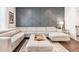 Stylish living room features an accent wall and large sectional sofa at 505 Hampton Crossing, Woodstock, GA 30188