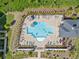 Overhead shot of a community swimming pool with lounge chairs, umbrellas, landscaping, and a nearby clubhouse at 505 Hampton Crossing, Woodstock, GA 30188